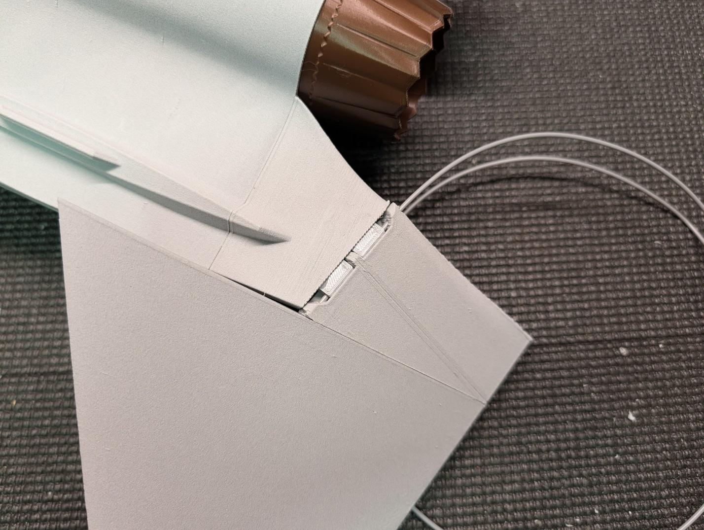 Filament hinge inserted through the hinge blocks