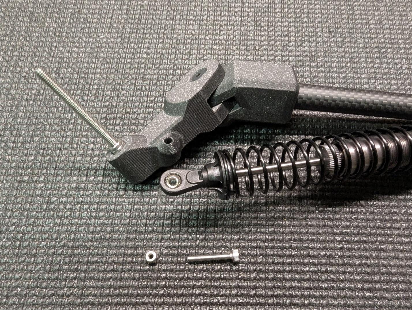 Shock absorber lower end secured