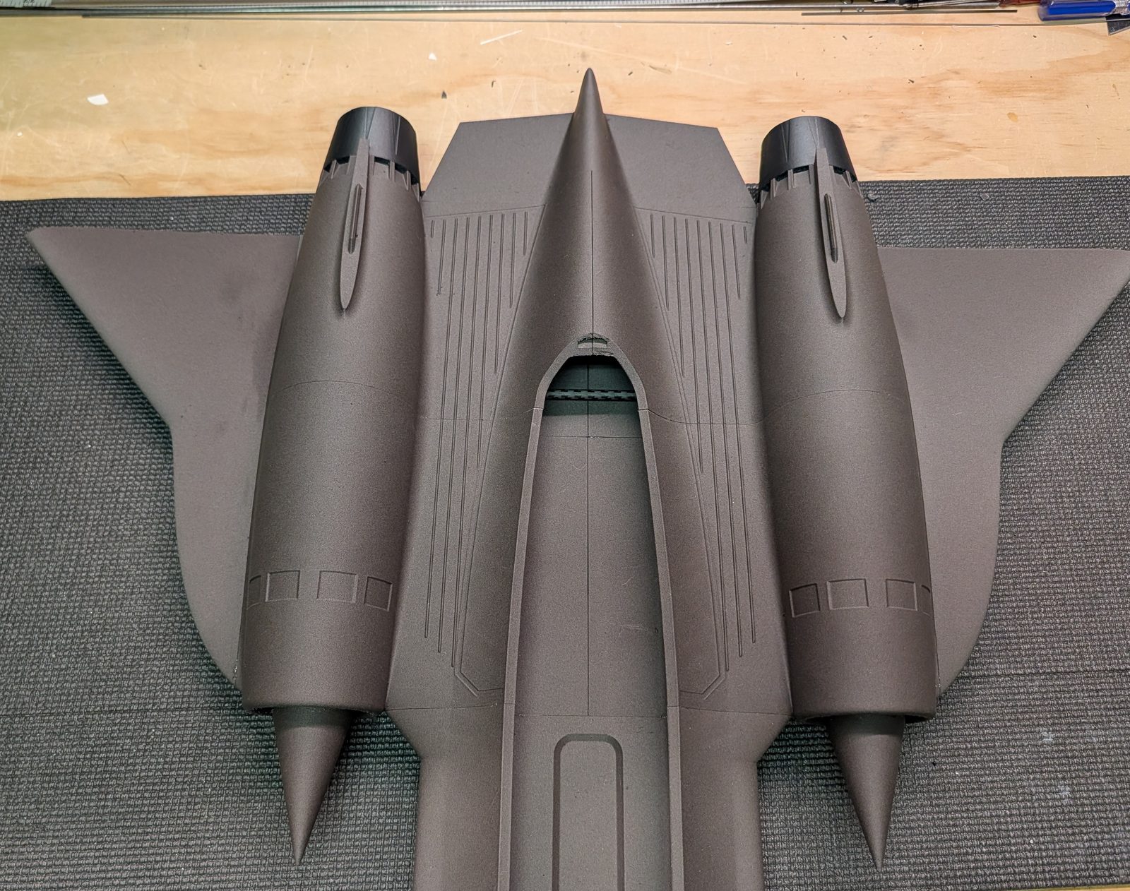 Gluing a wing section to the fuselage assembly