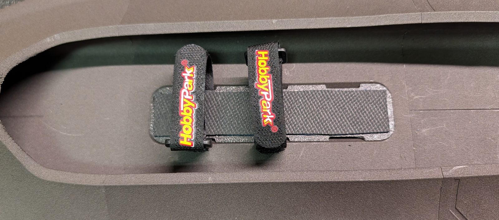 Battery bay with hook-and-loop straps