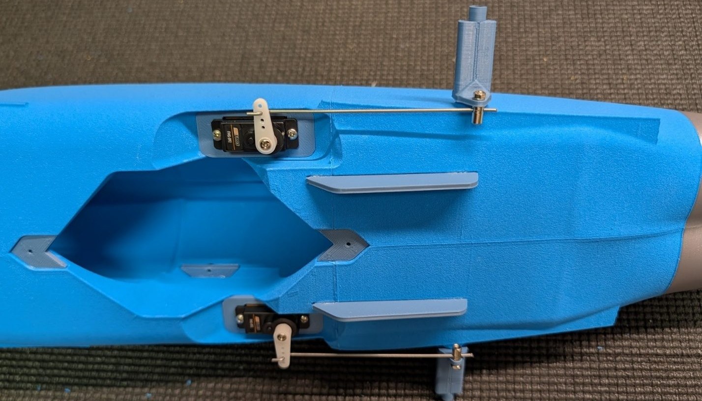 Pushrods connected to servo arms and pivot blocks