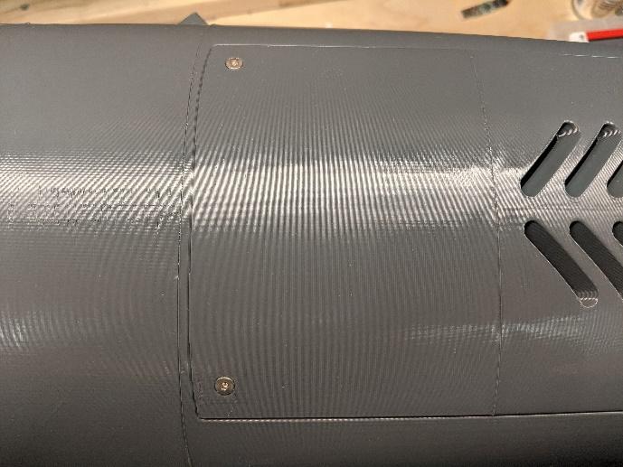 Fan hatch secured with flat-head screws